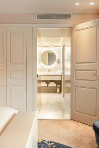 a bathroom with a door and a mirror at Hotel 717 in Amsterdam