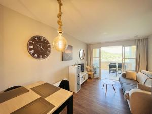 a living room with a clock on the wall at La Perle Blanche in Saint-Raphaël