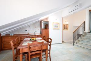 a dining room with a table and chairs and stairs at Villa Meri in Trogir