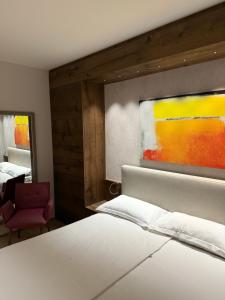 阿斯科纳Appartement Suite Delta Resort 714的卧室里有一张白色的床，墙上挂着一幅画