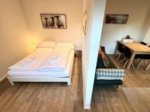 a small bedroom with a bed and a table at Studio in Chalet Lucia - Der Traum am Bach in Leukerbad