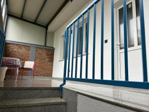 a building with blue and white doors and a table and chairs at Apartman Galah in Vukovar