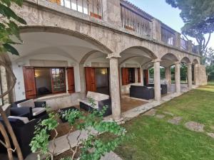 an external view of a building with chairs and a yard at Villa de lujo con piscina, jardín y vistas al mar, a 100m de la playa en S'Agaró - ES-209-27 in S'Agaro