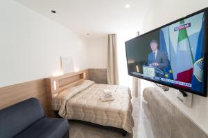 a living room with a flat screen tv on a wall at GreRos Toledo H Historical Center in Naples, by ClaPa Group Dislocated Hospitality in Naples