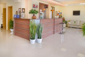 a waiting room with potted plants in a lobby at Family Hotel Vega in Saints Constantine and Helena +36 photos
