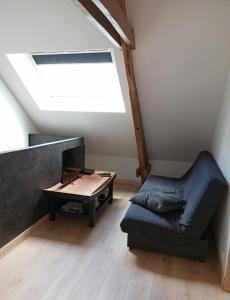 a living room with a couch and a table at Gîte - La Maison in Kernascléden