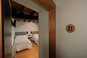 a bedroom with two beds and a door with the number at Hosteria de Zubiri in Zubiri +95 photos