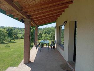 a patio with a table and chairs on a house at Casa Toscana snagov-ciolpani in Piscu