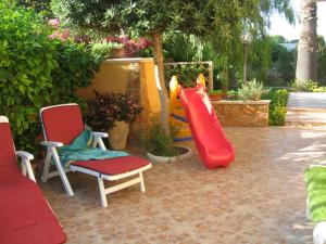 a playground with two chairs and a slide at Appartamento Arenella in Arenella