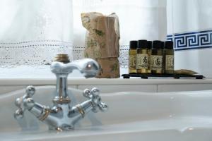 a bathroom sink with a faucet and a roll of toilet paper at Hosteria de Zubiri in Zubiri