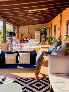 an outdoor patio with couches and tables and a table at B&B Sole e Luna in Palermo
