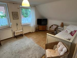 a living room with a bed and a tv at Apartment für zwei in Isenbüttel