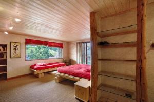 a bedroom with a bed and a book shelf at La Ferme du Soleil in Albiez-Montrond