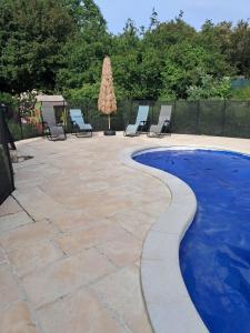 a patio with chairs and a swimming pool at cottage LES SENS CIEL in Saint-Martin