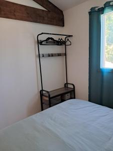 a bedroom with a bed and a chair next to a window at cottage LES SENS CIEL in Saint-Martin +14 photos