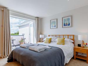 a bedroom with a bed and a large window at 3 Bed in Saint Just in Roseland 81488 in Saint Just in Roseland