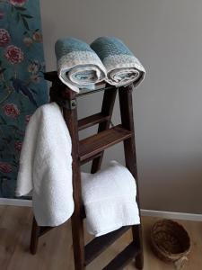 a wooden towel rack with towels on it at La Maison Bleue - La Belle Epoque in Rosières