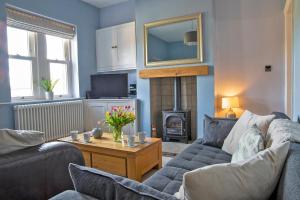 a living room with two couches and a fire place at Knowsley in Bakewell