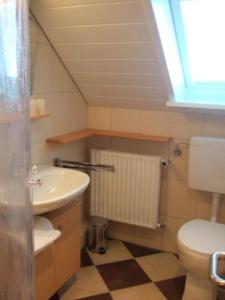 a bathroom with a toilet and a sink at Große Auszeit in Fehmarn