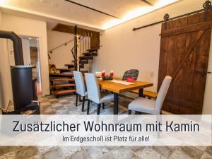 a dining room with a wooden table and chairs at Ferienwohnung im Sauerland Hunde willkommen Kamin und Garten am Waldrand Muehls-Sauerland in Lennestadt +59 photos
