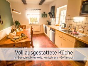 a kitchen with a wooden table and a kitchen with a sink at Muehls-Sauerland familienfreundlich Perfekt für deine Urlaubsrunde nähe Elspe Festival Hunde willkommen mit Kamin und Garten in Lennestadt