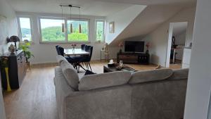 a living room with a couch and a table at Ferienwohnung Seerandweg in Simmerath