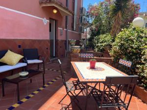 a patio with a table and chairs and a couch at Etna View Affittacamere in Giardini Naxos
