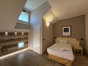 a small bedroom with a bed and a window at La Bergamina Hotel & Restaurant in Arcore +51 photos