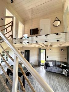 a living room with a staircase in a house at Zacisze Mrozy in Ełk +100 photos