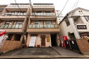 an apartment building in a city with a driveway at goom Monthly Nakasu Maxim in Fukuoka
