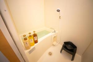 a small bathroom with alcohol bottles on a shelf at goom Monthly Nakasu Maxim in Fukuoka