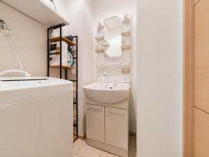 a white bathroom with a sink and a mirror at Ikebukuro 10 min-Family-Friendly Stay-Mobile Wi-Fi&Switch-Net in Tokyo +37 photos