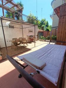 a mattress laying on a patio with a table and chairs at Casa Vacanza Ottavia Roma in Rome