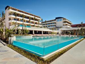 a swimming pool in front of a hotel at XO CAPE ARNNA Fethiye in Fethiye