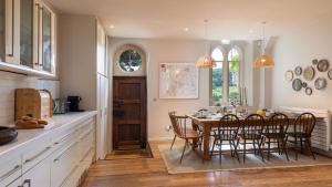 a kitchen with a table and chairs and a dining room at The Old Chapel in Painswick