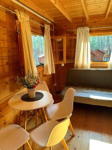 a room with a bed and a table and chairs at Perła in Stegna