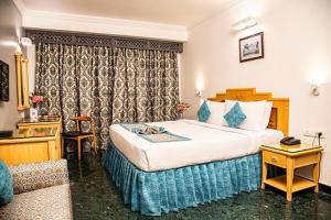 Postel nebo postele na pokoji v ubytování Golden Parkk Hotel