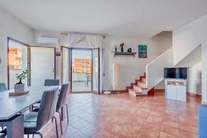 a dining room and living room with a table and chairs at Pinohaus in Ladispoli