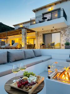 a living room with a couch and a table with wine glasses at Calliste Villa in Évyiros