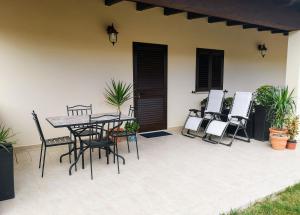 a patio with a table and chairs next to a house at Villa Azzurra in Lampedusa