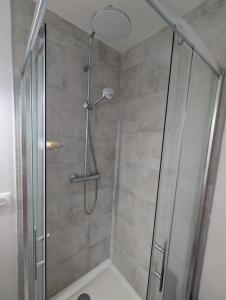 a bathroom with a shower with a glass door at Anglet, Chambre chez l'habitant in Anglet