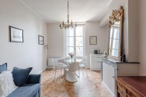 a living room with a table and a couch at Château de Bayssan in Béziers