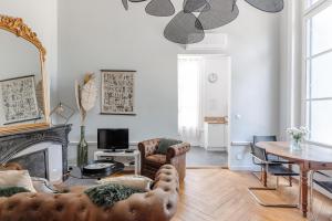 a living room with a couch and a fireplace at Château de Bayssan in Béziers