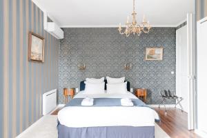 a bedroom with a large bed with blue walls at Château de Bayssan in Béziers +94 photos
