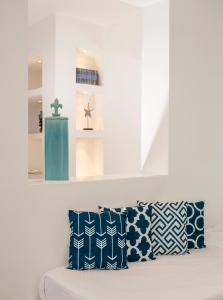 a room with blue and white pillows on a couch at Relais Blu in Massa Lubrense