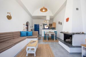 a living room with a couch and a fireplace at Villa Milla in Gennadi