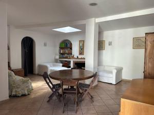 a living room with a table and a couch at Villa Robienne in Forio d'Ischia