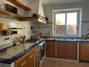 a kitchen with a sink and a window at Villa Robienne in Forio d'Ischia +19 photos