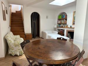 a living room with a wooden table and chairs at Villa Robienne in Forio d'Ischia