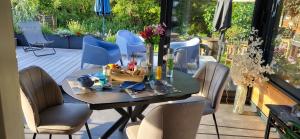 a dining table and chairs on a patio at Maison bretonne proche plage in Pénestin
